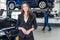 Portrait Of Beautiful Young Businesswoman In Car Garage