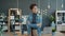 Portrait of beautiful young businesswoman standing in office with serious face thinking