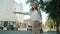 Portrait of beautiful young businesswoman waiting for taxi outside in city street