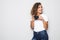 Portrait of beautiful young curly mixed race woman photographer isolated over white background holding camera.