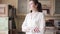 Portrait of a beautiful young female saleswoman in a furniture store. The happiness manager looks into the camera