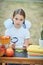 Portrait of a beautiful young first-grader sitting at a desk on the background autumn park. Farewell Bell. day of knowledge. begin