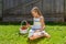 Portrait of beautiful young girl with basket of strawberries.