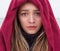 Portrait of a beautiful young girl with big eyes with a sad mood, sadness on her face with krestnym handkerchief on head