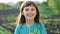 Portrait of a beautiful young girl blowing on the ripened dandelion in the evening against the background of the sunset