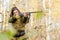 Portrait of a beautiful young girl in camouflage hunter with shotgun