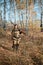 Portrait of a beautiful young girl in camouflage hunter with shotgun