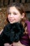 Portrait of a beautiful young girl and her newfoundland puppy hugging