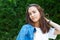 Portrait of beautiful young girl posing in summer park. Majestic woman`s beauty. Youth, happiness