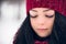 Portrait of a beautiful young girl with snowflakes on her eyelashes