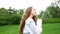 Portrait of a beautiful young girl with very long curly hair posing at the camera. An attractive fashion woman model