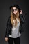 Portrait of beautiful young girl wearing black felt hat, Sunglasses and leather jacket