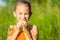 Portrait of a beautiful young girl with wildflowers in park