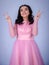 Portrait Of Beautiful Young girle Standing Against blue Background,girl in a pink dress,Happy cheery smiling young cute girl