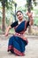 Portrait of beautiful young Indian classical odissi dancer wears traditional costume and posing Odissi dance mudra in the