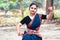 Portrait of beautiful young Indian classical odissi dancer wears traditional costume and posing Odissi dance mudra in the