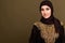 Portrait of beautiful young muslim arabian woman wearing hijab looking at camera, copy space