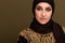Portrait of beautiful young muslim arabian woman wearing hijab looking at camera, copy space