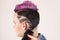 Portrait of a beautiful young teenager with a beautiful creative hairstyle, hair painted in pink