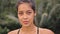 Portrait of beautiful young tired and sweaty woman boxer turning face to camera with serious look. Close up of pretty