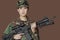 Portrait of beautiful young US Marine Corps soldier with M4 assault rifle over brown background