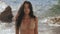 Portrait of beautiful young woman in bikini on beach.