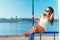 Portrait of beautiful young woman in bikini on beach sunbathing.