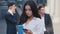 Portrait of Beautiful Young Woman Businesswoman using SmartPhone on Coffe Break outdoor on Streets of Business District