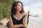 Portrait of a beautiful young woman with dark hair, on the beach, sensual portrait, natural beauty