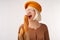 Portrait of a beautiful young woman holding baguette in her hands. Cheerful woman in yellow beret