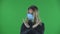 Portrait of beautiful young woman in medical protective face mask looking at camera and strictly gesticulates with hands