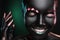 Portrait of beautiful young woman with surreal makeup on dark background, closeup