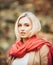 Portrait of beautiful young woman walking outdoors in autumn. Fashion woman in autumn country style. Closeup face of