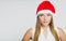 Portrait of beautiful young woman wearing santa claus hat
