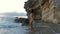 Portrait of beautiful young woman on wild rocky beach.