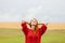 Portrait of beautiful young woman on the wonderful field and sky