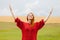 Portrait of beautiful young woman on the wonderful field and sky