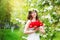 Portrait of a beautiful young woman in a wreath of spring flower