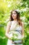 Portrait of a beautiful young woman in a wreath of spring flower