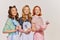 Portrait of beautiful young women, housewives with cooking tools isolated over grey background. Pop art