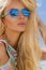 Portrait beauty stunning blonde model with perfect face wearing a sunglasses and elegant white bikini