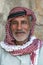 A portrait of a Bedouin man wearing traditional headware in Jordan.