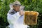 Portrait of beekeeper with honeycomb