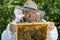 Portrait of beekeeper with honeycomb