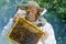 Portrait of beekeeper with honeycomb