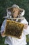 Portrait of beekeeper with honeycomb