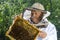 Portrait of beekeeper with honeycomb