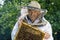 Portrait of beekeeper with honeycomb