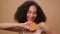 Portrait in beige background advertise female girl African American woman hold half of orange citrus vitamin pampering