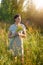 Portrait of a beuatiful young woman holding wildflowers